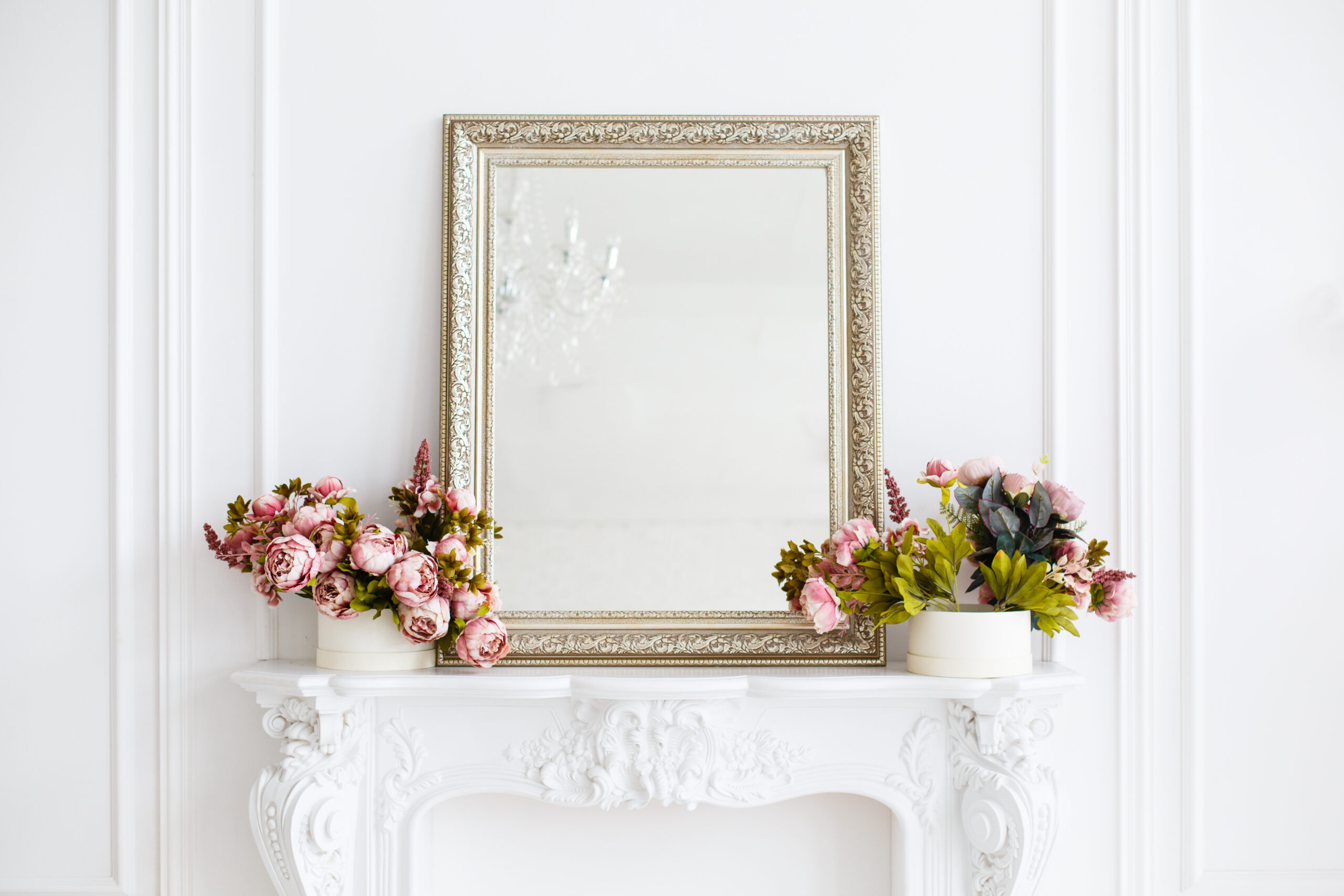 Custom mirror with custom frame on decorative shelf with flowers